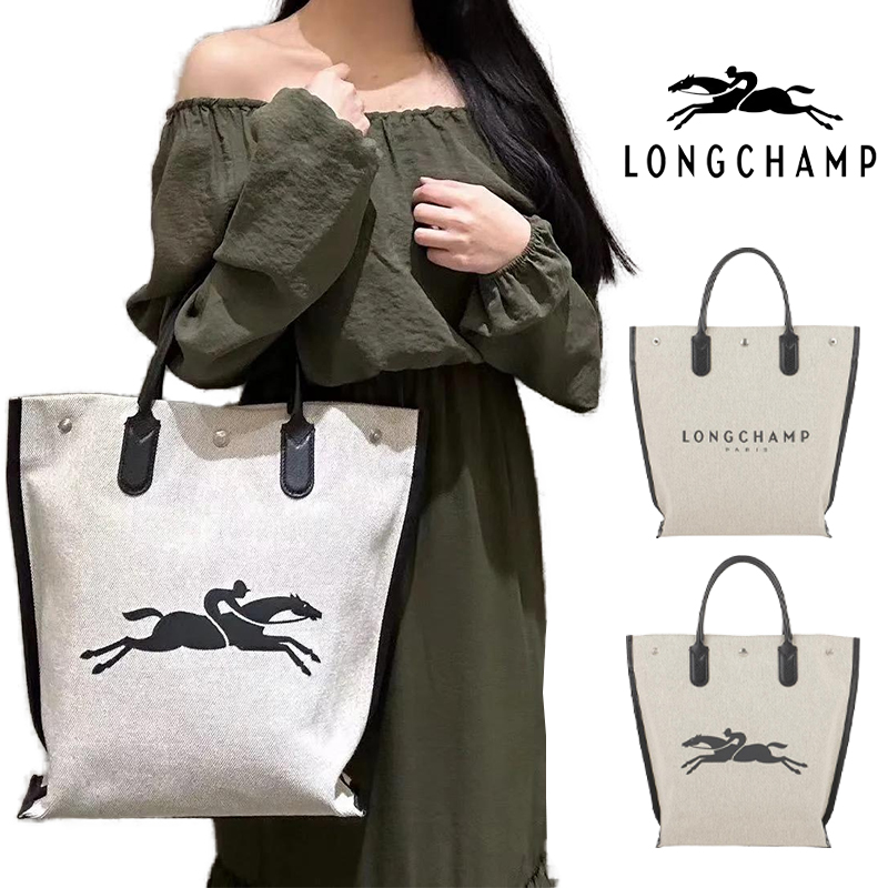 斑入りのコットンキャンバスを使用したトートバッグ。 表面にはLONGCHAMPロゴが、背面には馬に乗った騎手のプリントが大きくあしらわれています。 カジュアルな素材をブラックレザーのトリミングとハンド